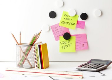 Magnettavle der hænger over et skrivebord